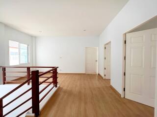 Spacious well-lit interior space with wooden flooring