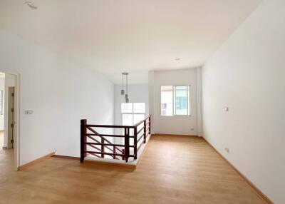 Spacious unfurnished living room with hardwood floors and natural lighting
