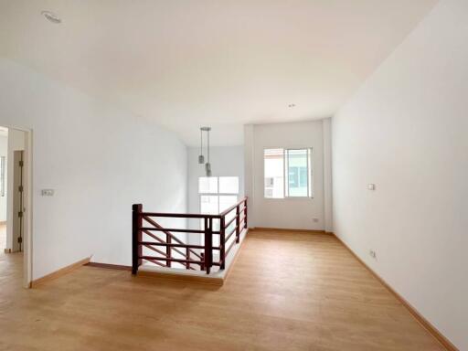 Spacious unfurnished living room with hardwood floors and natural lighting