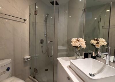 Modern bathroom with glass shower enclosure and sleek basin