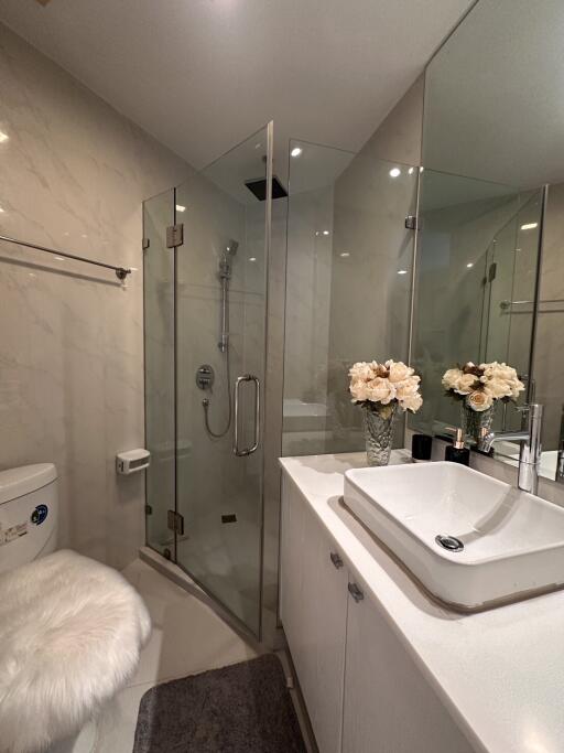 Modern bathroom with glass shower enclosure and sleek basin