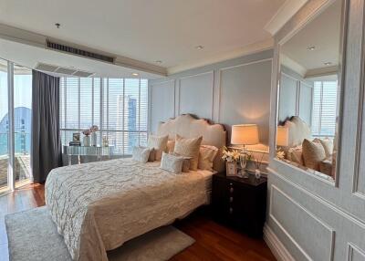 Spacious bedroom with city view, elegantly furnished and well-lit