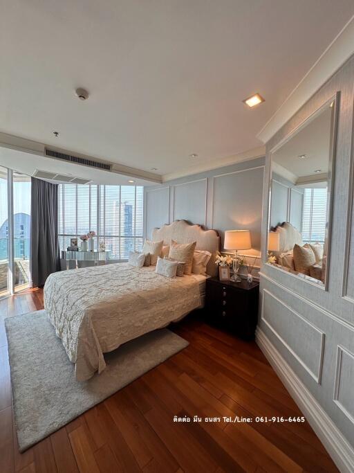 Spacious bedroom with city view, elegantly furnished and well-lit