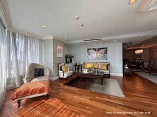 Spacious and elegantly furnished living room with large windows