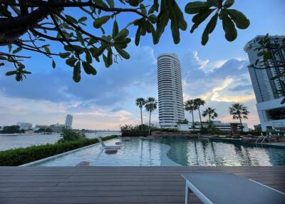 Luxurious pool with a view of a high-rise building at dusk