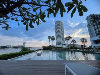 Luxurious pool with a view of a high-rise building at dusk