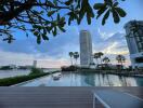 Luxurious pool with a view of a high-rise building at dusk