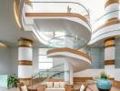 Elegant multi-level atrium with spiral staircase and modern furnishings