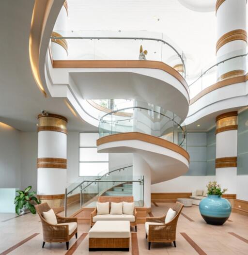 Elegant multi-level atrium with spiral staircase and modern furnishings