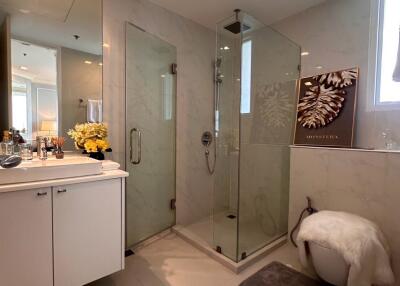 Spacious modern bathroom with glass shower and elegant vanity