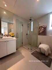 Spacious modern bathroom with glass shower and elegant vanity