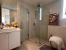 Spacious modern bathroom with glass shower and elegant vanity