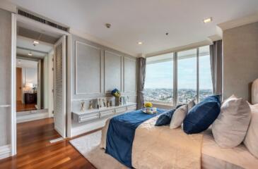 Spacious bedroom with large windows and city view