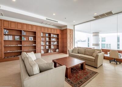 Spacious living room with modern furniture and large bookshelf