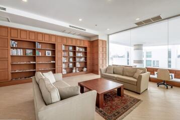 Spacious living room with modern furniture and large bookshelf