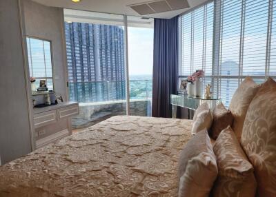 Modern bedroom with city view and large windows