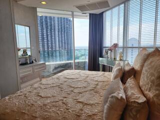 Modern bedroom with city view and large windows