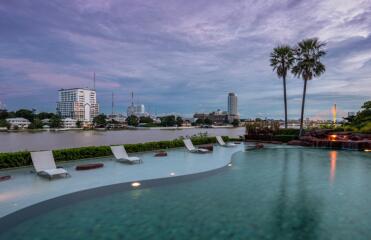 Tranquil outdoor swimming pool with skyline view at dusk