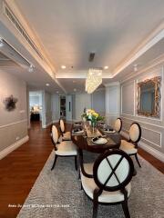 Elegant dining room with a wooden round table and upholstered chairs
