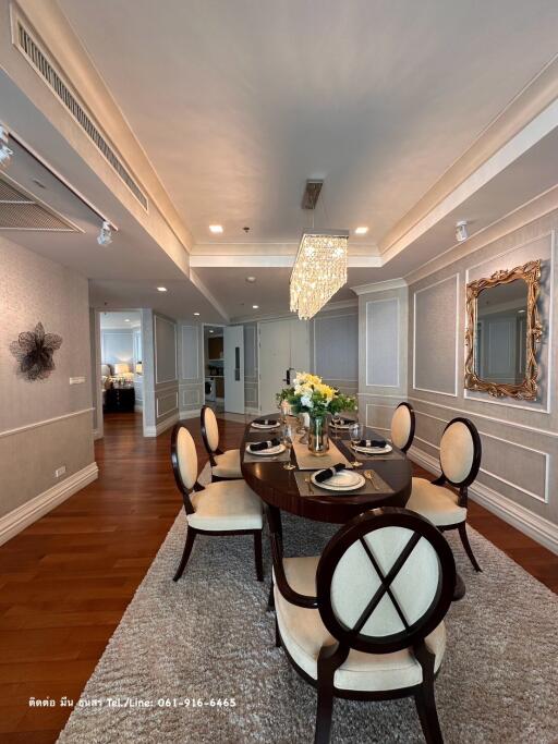 Elegant dining room with a wooden round table and upholstered chairs