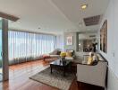 Spacious living room with abundant natural light and modern furnishings