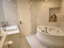 Modern bathroom with white marble tiles featuring a whirlpool bathtub and enclosed glass shower