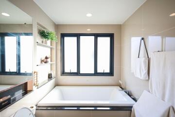 Modern bathroom with large windows and a bathtub