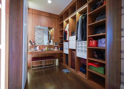 Spacious walk-in closet with custom shelving and dressing area