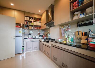 Modern kitchen with wooden cabinets and well-equipped appliances