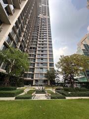 Modern high-rise residential building with landscaped garden