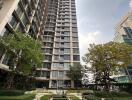 Modern high-rise residential building with landscaped garden