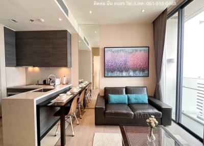 Modern and sleek combined living and dining room with kitchenette and balcony access