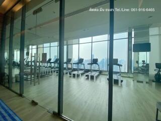 Spacious gym with modern equipment and panoramic city views