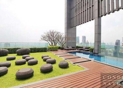 Modern rooftop garden with city view, wooden decking, and outdoor furniture