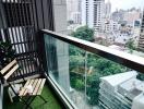 Urban balcony with artificial grass overlooking the city