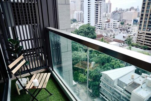 Urban balcony with artificial grass overlooking the city