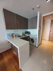 Compact contemporary kitchen with modern appliances and wooden flooring