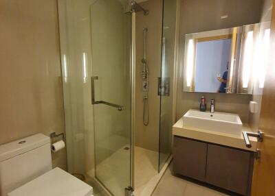 Modern bathroom with glass shower and vanity mirror