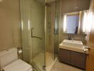 Modern bathroom with glass shower and vanity mirror