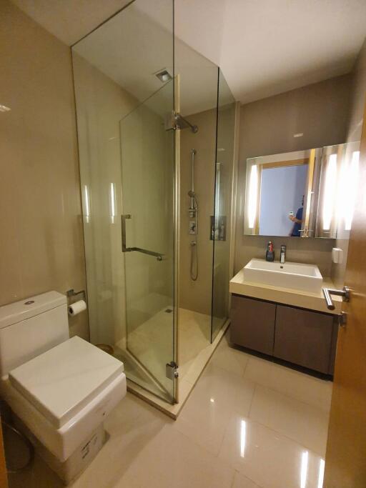 Modern bathroom with glass shower and vanity mirror