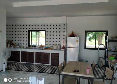 Modern kitchen with black and white tiled floor