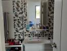 Modern bathroom with patterned wall tiles and white fixtures