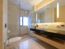 Modern bathroom interior with glass shower and double vanity