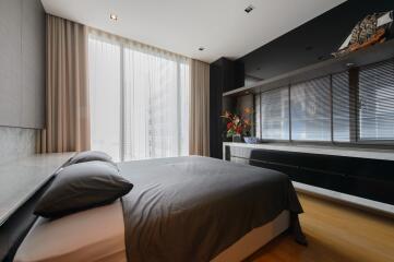Modern bedroom with large bed and window seating area