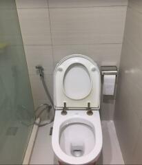 Clean white bathroom toilet with wall tiles