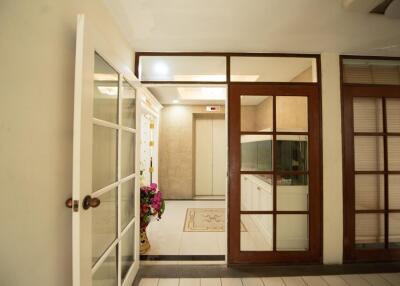 Bright and welcoming entrance hall with French doors and tiled flooring