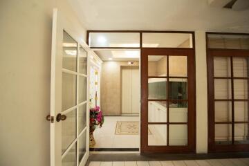 Bright and welcoming entrance hall with French doors and tiled flooring