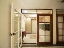 Bright and welcoming entrance hall with French doors and tiled flooring