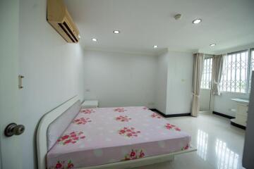 Bright and spacious bedroom with large window and air conditioning