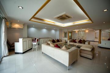 Spacious and modern living room with elegant furniture and sophisticated lighting